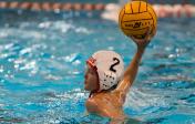 boy playing water polo, about to throw ball